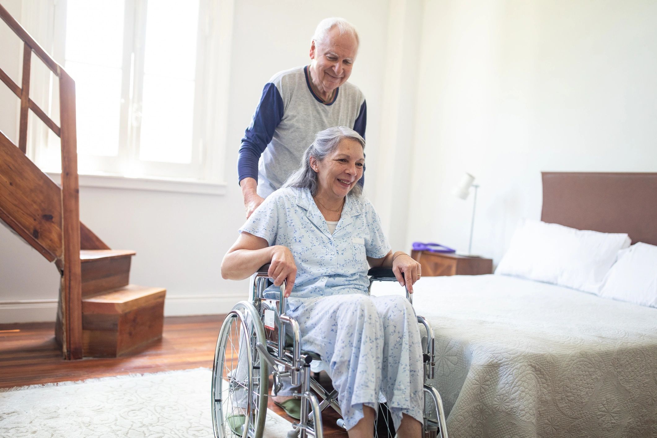 Caregiver assisting a senior woman in a bright premium care setting