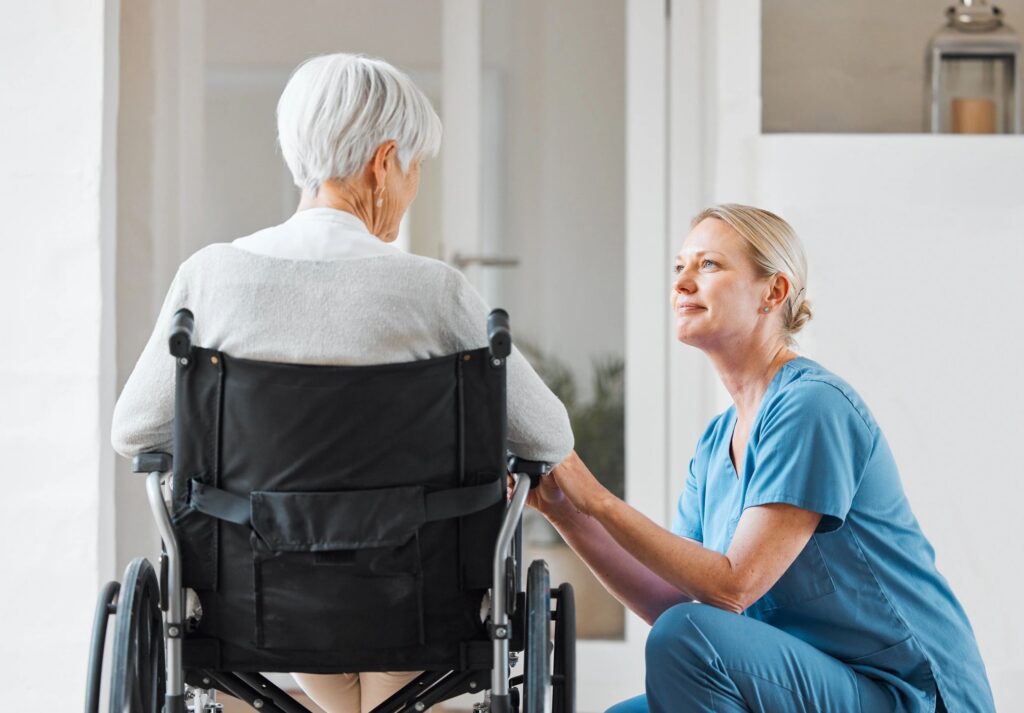Shot of a nurse caring for a senior woman in a wheelchair in a retirement home