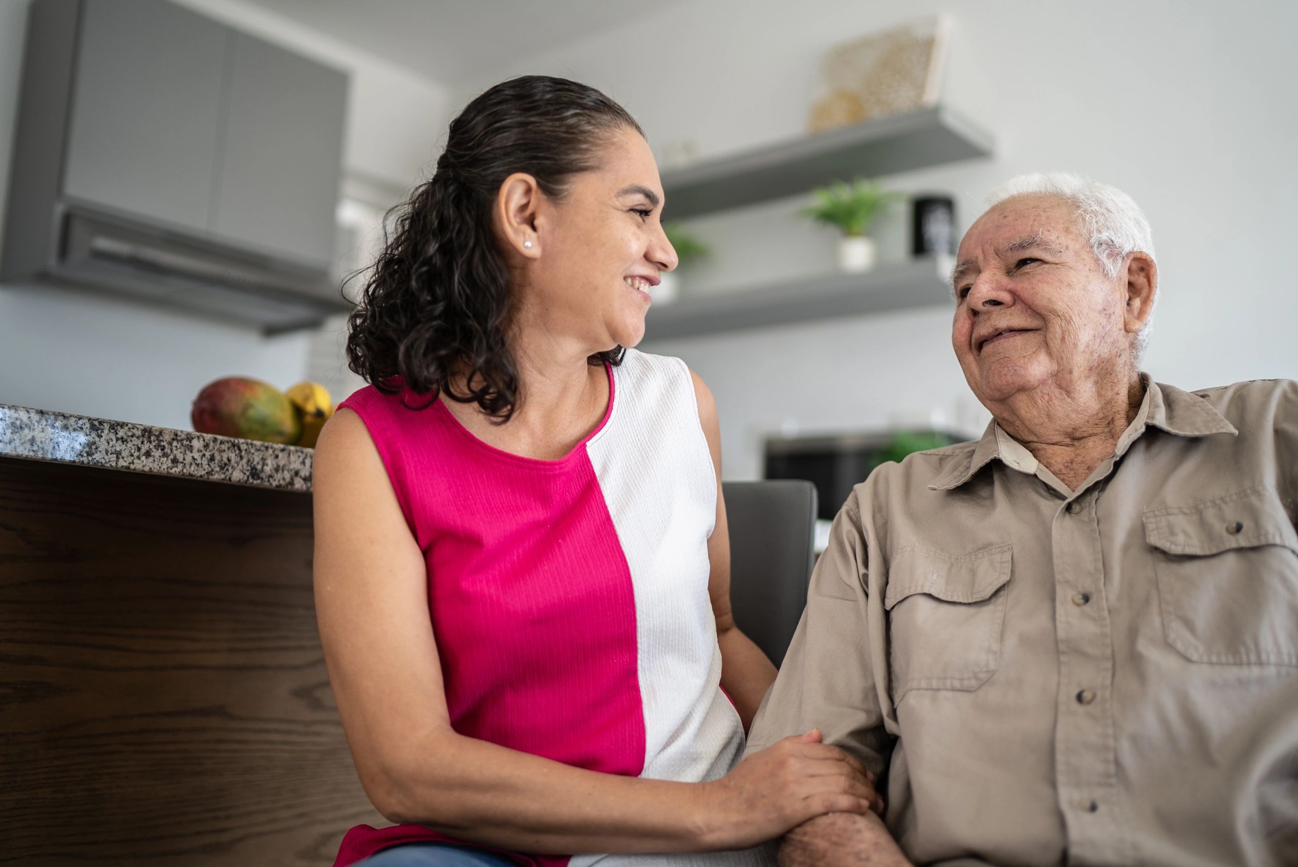 Senior man speaking with a caregiver at home