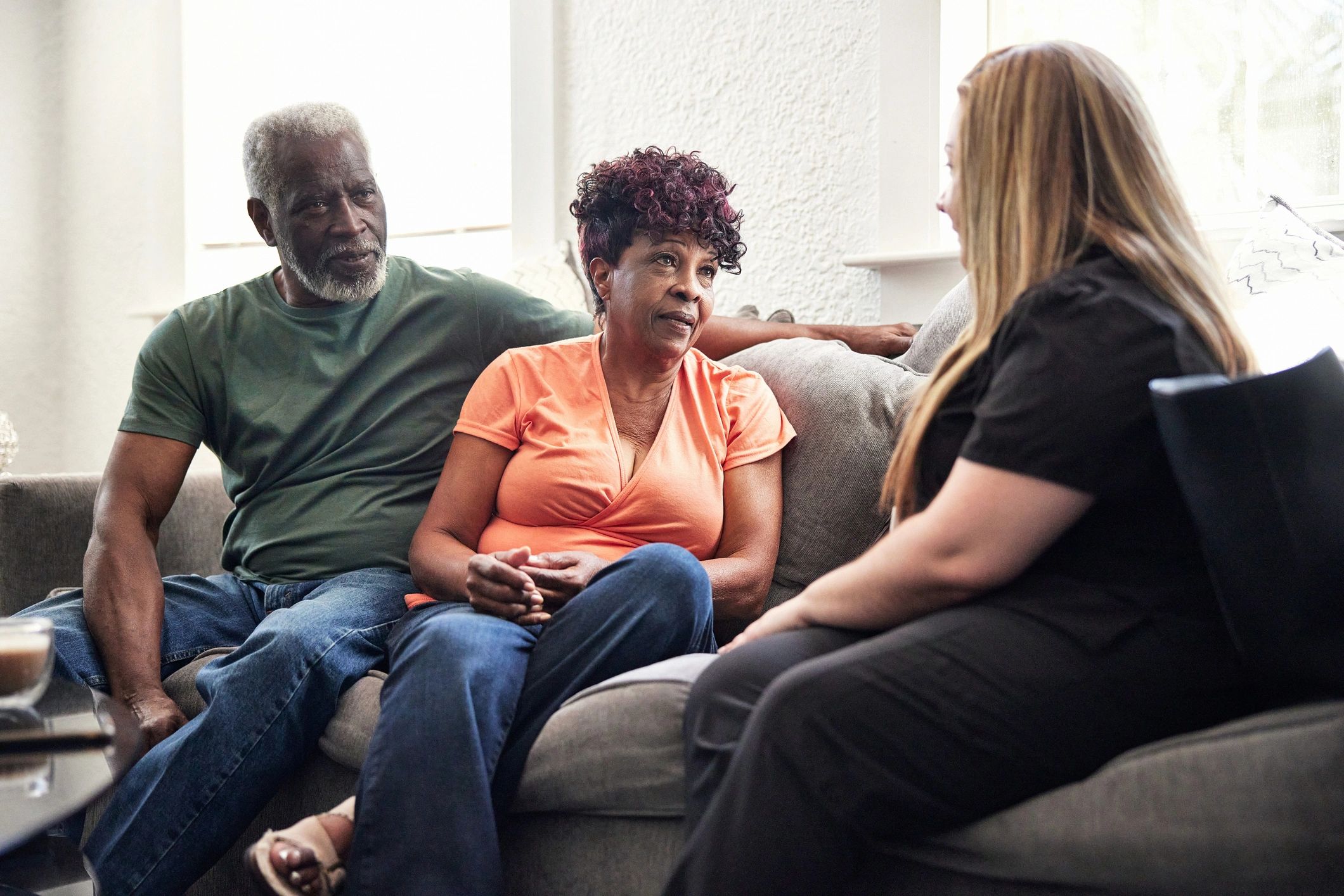 Caregiver speaking with senior clients at home