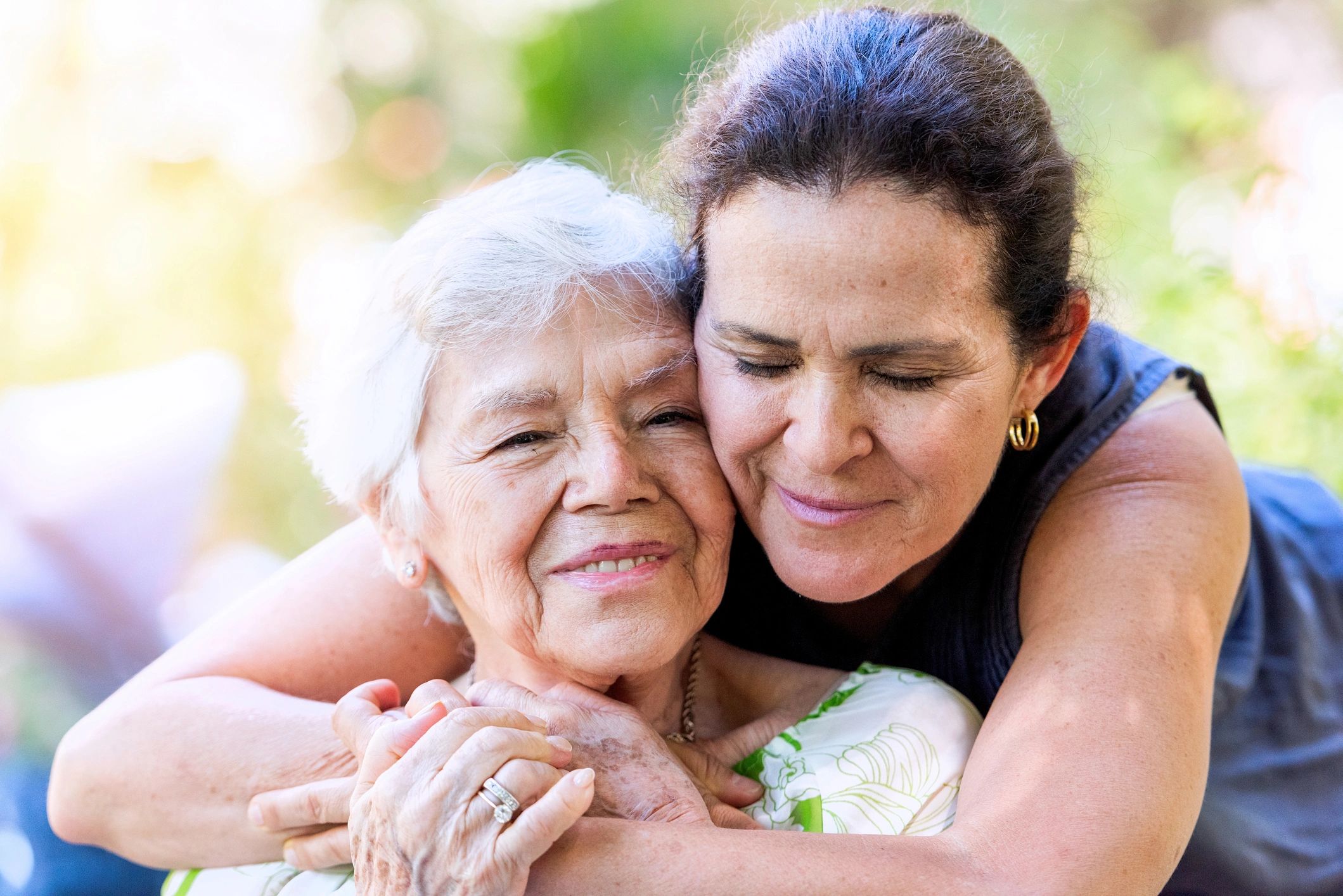 Mature woman hugging her senior mother