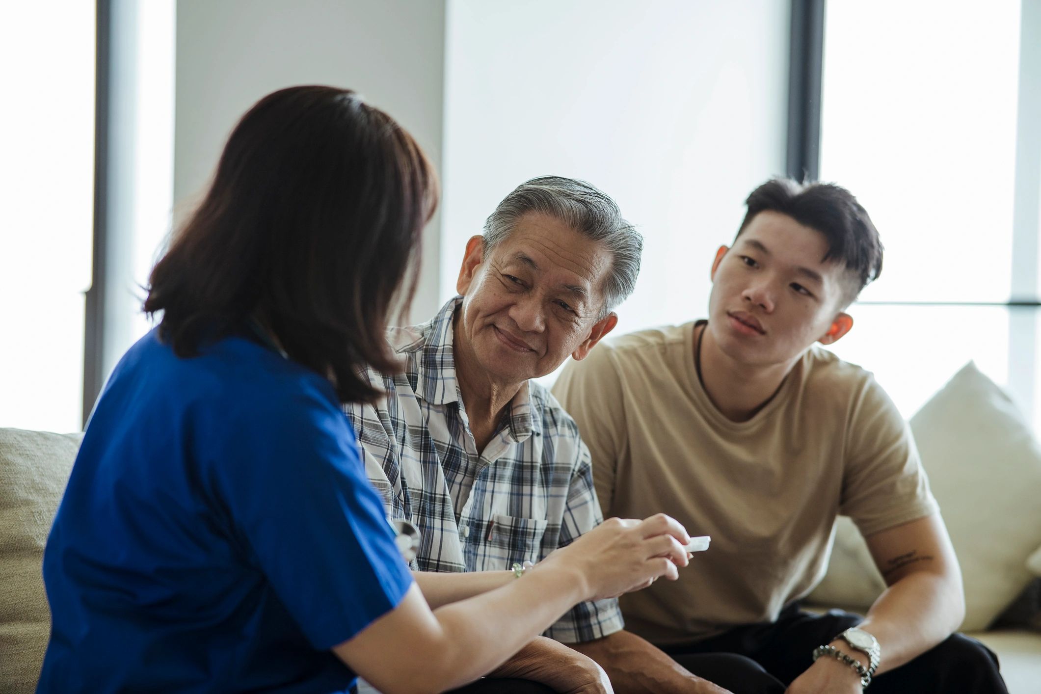 Family caregiver supporting elderly patient during consultation