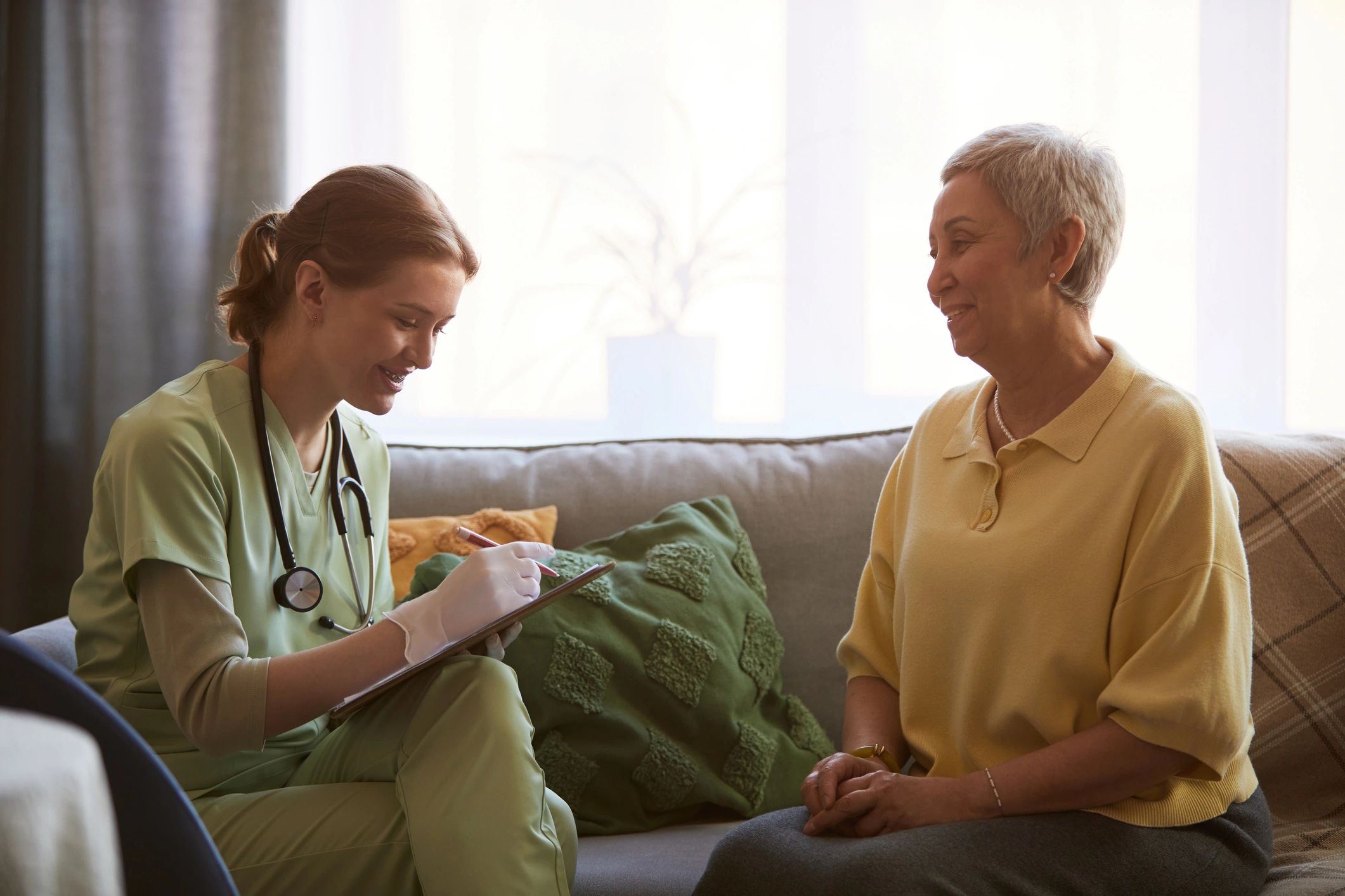 Premium in-home care consultation with senior client in an elegant bright setting