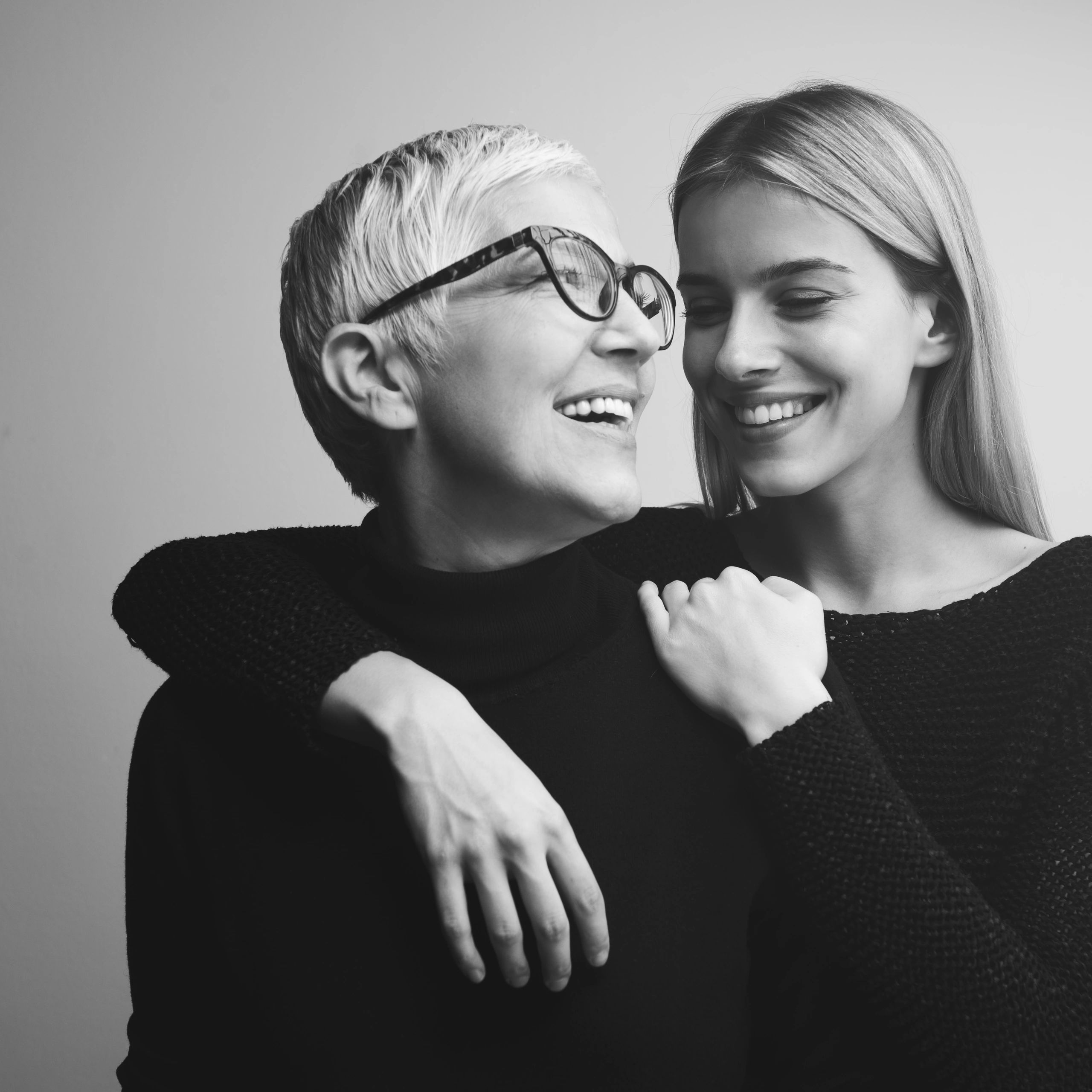 Portrait of a senior woman with her adult daughter at home